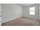 Neutral carpeted bedroom with a window for natural light at 30732 Summer Sun Loop, Wesley Chapel, FL 33545