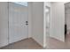 Clean entryway showcasing tile flooring and access to adjacent rooms at 30732 Summer Sun Loop, Wesley Chapel, FL 33545