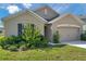 Inviting home featuring a well-maintained lawn and attached two-car garage at 30732 Summer Sun Loop, Wesley Chapel, FL 33545