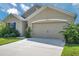 Charming home featuring an attached two-car garage and manicured landscaping at 30732 Summer Sun Loop, Wesley Chapel, FL 33545