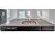 Kitchen island with stainless steel sink and granite countertops overlooking the open living area at 30732 Summer Sun Loop, Wesley Chapel, FL 33545