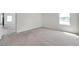 Bright living area with view into other spaces; natural light accents the carpeted floors and neutral walls at 30732 Summer Sun Loop, Wesley Chapel, FL 33545