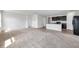 Spacious living area showcasing an open layout connected to a kitchen with modern dark cabinets at 30732 Summer Sun Loop, Wesley Chapel, FL 33545