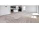 Open floor plan combining living space with kitchen featuring dark cabinetry and granite countertops at 30732 Summer Sun Loop, Wesley Chapel, FL 33545