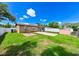 Well-maintained backyard featuring a green lawn, brick patio, storage shed, and a fenced perimeter at 3303 W Idlewild Ave, Tampa, FL 33614