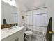 Bathroom featuring a modern vanity, a large mirror, and a shower with a stylish shower curtain at 3303 W Idlewild Ave, Tampa, FL 33614