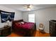 Cozy bedroom with a plush bed, wood floors, a ceiling fan and a large window at 3303 W Idlewild Ave, Tampa, FL 33614