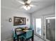 Dining area featuring a modern table set and a mirror reflecting the kitchen at 3303 W Idlewild Ave, Tampa, FL 33614