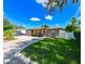 Quaint single-story house with a lush lawn and a long, paved driveway at 3303 W Idlewild Ave, Tampa, FL 33614