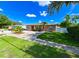 Cozy home featuring a well-maintained lawn, mature trees, and a long driveway at 3303 W Idlewild Ave, Tampa, FL 33614