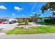 Attractive single-story home featuring a neatly landscaped yard and long driveway at 3303 W Idlewild Ave, Tampa, FL 33614