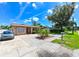 Charming one-story house featuring tidy landscaping and a well-kept lawn at 3303 W Idlewild Ave, Tampa, FL 33614