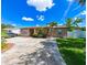Inviting single-story home with lush green lawn, and convenient driveway at 3303 W Idlewild Ave, Tampa, FL 33614