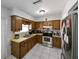 A kitchen with stainless steel appliances, tile flooring, and wooden cabinets is a functional and stylish space at 3303 W Idlewild Ave, Tampa, FL 33614