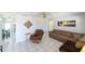 Spacious living room with tile floors, a ceiling fan, and comfortable seating at 3303 W Idlewild Ave, Tampa, FL 33614