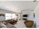 Bright living room features tiled floor, neutral walls, a ceiling fan, and large windows at 3303 W Idlewild Ave, Tampa, FL 33614