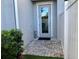 Back entrance features a glass door, stone pavers, and a small, well-maintained lawn at 3807 W Cleveland St, Tampa, FL 33609