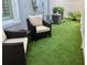 Backyard featuring artificial turf and cozy seating, perfect for outdoor relaxation and entertaining at 3807 W Cleveland St, Tampa, FL 33609