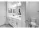 Well-lit bathroom featuring a double vanity with sleek hardware and ample counter space at 3807 W Cleveland St, Tampa, FL 33609