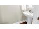 Compact half bath featuring a pedestal sink at 3807 W Cleveland St, Tampa, FL 33609