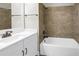 The bathroom features a tub with shower and a white vanity at 3807 W Cleveland St, Tampa, FL 33609