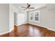 This bedroom has two windows, a ceiling fan, hardwood floors, neutral paint, and a closet entrance at 3807 W Cleveland St, Tampa, FL 33609