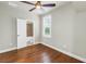 Cozy bedroom with hardwood floors, plantation shutters, and a ceiling fan for added comfort at 3807 W Cleveland St, Tampa, FL 33609
