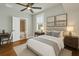 Comfortable bedroom featuring an en-suite bathroom, hardwood floors, and minimalist decor for a peaceful environment at 3807 W Cleveland St, Tampa, FL 33609