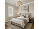 Cozy bedroom featuring a queen-sized bed, neutral decor, and soft lighting, creating a relaxing retreat at 3807 W Cleveland St, Tampa, FL 33609