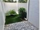 A quaint courtyard featuring artificial turf, a palm tree, and a stone-paved area at 3807 W Cleveland St, Tampa, FL 33609