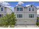 Charming two-story townhouse featuring a two-car garage, neutral color palette, and paver driveway at 3807 W Cleveland St, Tampa, FL 33609