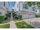 Townhouse exterior with a two-car garage, neatly trimmed shrubs, and a walkway to the entrance, nestled in lush landscaping at 3807 W Cleveland St, Tampa, FL 33609