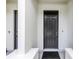 A covered front entrance with a dark door and matte at 3807 W Cleveland St, Tampa, FL 33609