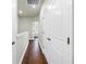 Hallway with wood floors, white trim, and natural light, creating an inviting transition space at 3807 W Cleveland St, Tampa, FL 33609
