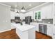 Spacious kitchen with white cabinets, stainless steel appliances, and a center island at 3807 W Cleveland St, Tampa, FL 33609