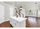 Kitchen island featuring white cabinets and hardwood floors at 3807 W Cleveland St, Tampa, FL 33609
