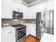 Modern kitchen features stainless steel appliances, white cabinets, and granite countertops at 3807 W Cleveland St, Tampa, FL 33609