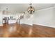 Spacious living room with hardwood floors leading to kitchen and staircase at 3807 W Cleveland St, Tampa, FL 33609
