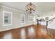 Bright living room featuring hardwood floors, lots of natural light, and an elegant decorative chandelier at 3807 W Cleveland St, Tampa, FL 33609