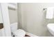 This powder room features a sleek toilet and floating sink, all complemented by a towel rack and wood-look flooring at 3807 W Cleveland St, Tampa, FL 33609