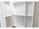 Spacious walk-in closet featuring custom white shelving and metal rods for optimal organization at 3807 W Cleveland St, Tampa, FL 33609