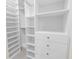 Custom walk-in closet featuring adjustable shelves, drawers, and hanging rods for efficient storage solutions at 3807 W Cleveland St, Tampa, FL 33609