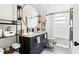 Stylish bathroom with dual sink vanity, round mirror, and a shower/tub combination at 403 E North St, Tampa, FL 33604
