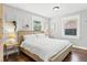 Cozy bedroom with hardwood floors, neutral walls, and ample natural light at 403 E North St, Tampa, FL 33604
