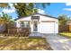 Charming home with a deck, white exterior, modern front door, and a one car garage at 403 E North St, Tampa, FL 33604