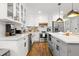 Bright white kitchen with island, stainless steel appliances, and granite countertops at 403 E North St, Tampa, FL 33604