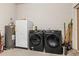 Utility room with side by side laundry and a spare refrigerator in a large open space at 403 E North St, Tampa, FL 33604