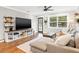 Comfortable living room with hardwood floors, large TV, and plenty of natural light at 403 E North St, Tampa, FL 33604