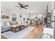 Bright, open floor plan with hardwood floors, grey sofa, and kitchen with island at 403 E North St, Tampa, FL 33604