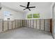 Bedroom featuring a ceiling fan, natural light from two windows and exposed block walls at 4101 Shore Acres Ne Blvd, St Petersburg, FL 33703
